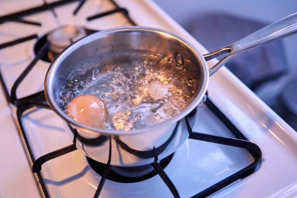 Boiling egg cooking egg boiled stock pictures, royalty-free photos & images