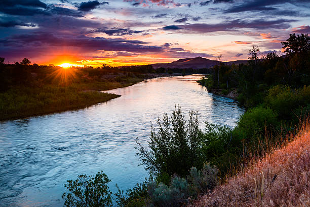 Boise river meandering through a lush landscape at sunset stock photo
