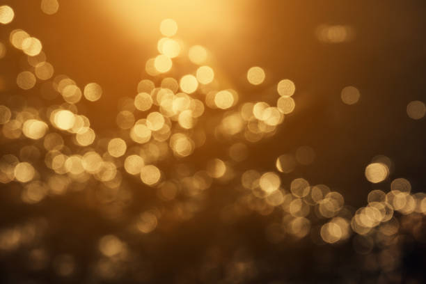 bokeh gold light backgrounds bokeh gold light backgrounds brown stock pictures, royalty-free photos & images