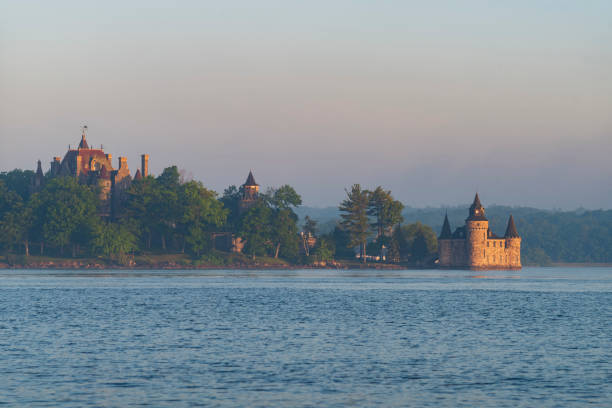 Boldt Castle, a major landmark and tourist attraction, is located in the Thousand Islands region of New York on Heart Island in the Saint Lawrence River, pictured here at sunrise. stock photo