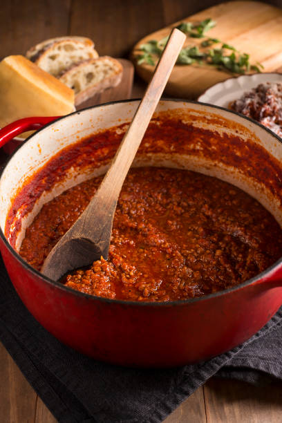 Boloagnese Sauce Bolognese Sauce Cooking In Enameled Cast Iron Dutch Oven bolognese sauce stock pictures, royalty-free photos & images