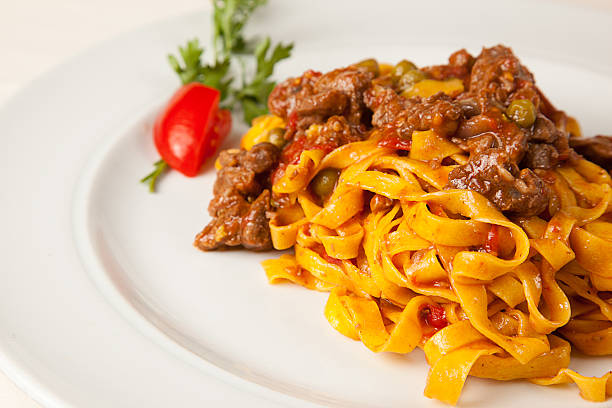 Bolognaise sauce and italian pasta tagliatelle A portion of tagliatelle, italian pasta romagnola, with bolognaise sauce tagliatelle stock pictures, royalty-free photos & images