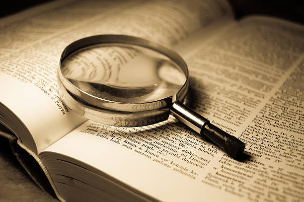 Book and glass loupe stock photo