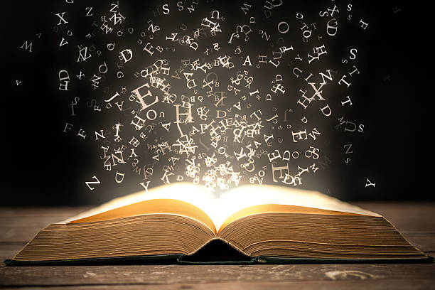 Book and glowing letters Open book and magical glowing letters. literature stock pictures, royalty-free photos & images