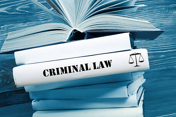 Book with Criminal Law word on table in a courtroom stock photo