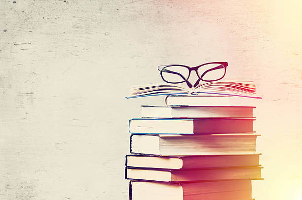 books and eyeglasses a pile of books and eyeglasses literature stock pictures, royalty-free photos & images