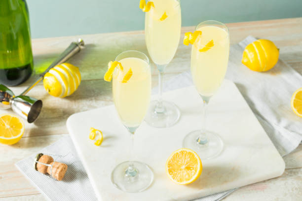 Boozy Bubbly Lemon French 75 Cocktail Boozy Bubbly Lemon French 75 Cocktail with Champagne french culture stock pictures, royalty-free photos & images