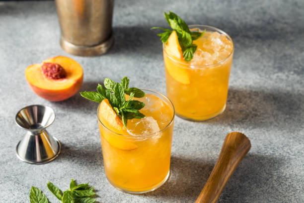 Boozy Refreshing Peach Bourbon Smash Cocktail stock photo