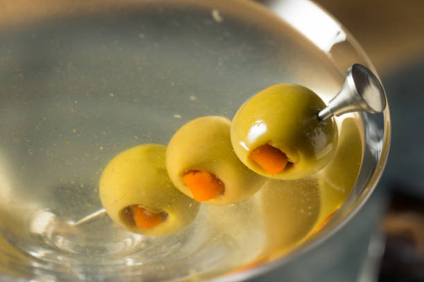Boozy Traditional Dirty Martini Boozy Traditional Dirty Martini with Olive Garnish dirty martini stock pictures, royalty-free photos & images