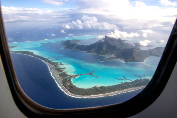 Bora Bora through the window Coming in for a landing on beautiful Bora Bora. French Polynesia, South Pacific Ocean. atoll stock pictures, royalty-free photos & images