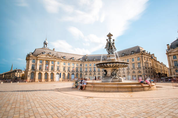 Bordeaux city in France View on the famous La Bourse square with fountain in Bordeaux city, France. Long exposure image technic with motion blurred people and clouds bordeaux photos stock pictures, royalty-free photos & images