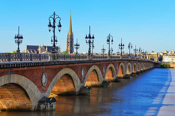 Bordeaux river bridge with St Michel cathedral in background stock photo
