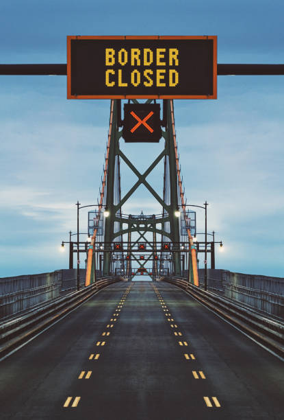 Border Closed Border closed displayed on overhead bridge sign. Composite image. border patrol stock pictures, royalty-free photos & images