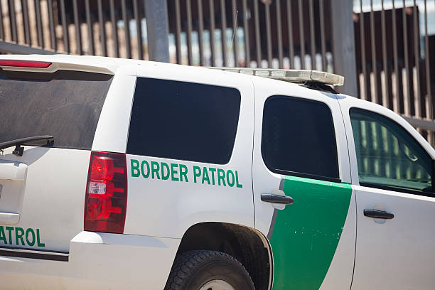 Border Partol at the US Mexico border in San Diego Border patrol car at the US border with Mexico in San Diego with the fence behind. border patrol stock pictures, royalty-free photos & images