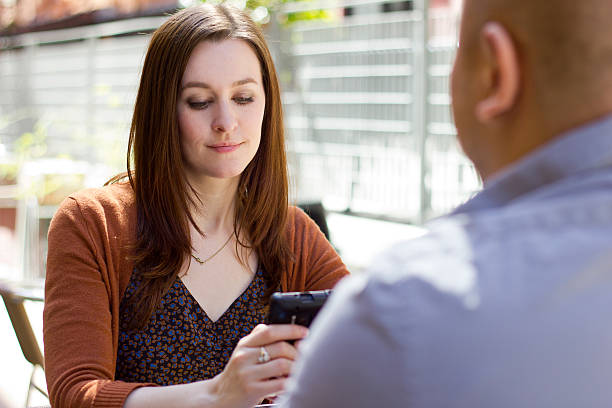 Bored Female on an Outdoor Date is Distracted by Phone stock photo