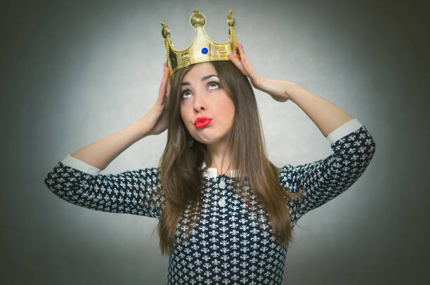 Bossy woman. Selfish girl. Egoist. Selfish woman. Arrogant girl with high self esteem. Egoist person woman with golden crown on her head. Winner. snob stock pictures, royalty-free photos & images