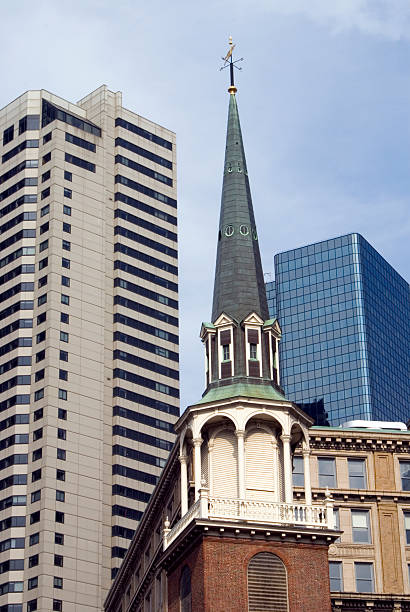 Boston - Old and New The "Old South Meeting House" where the famous Boston Tea Party was organized in 1773 appears in front of modern office buildings. boston tea party stock pictures, royalty-free photos & images