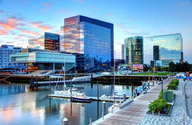 Boston's Seaport District The Seaport/Innovation District in the South Boston neighborhood is a rapidly transforming area in Boston. Boston is the largest city in New England, the capital of the state of Massachusetts. Boston is known for its central role in American history,world-class educational institutions, cultural facilities, and champion sports franchises. commercial dock photos stock pictures, royalty-free photos & images