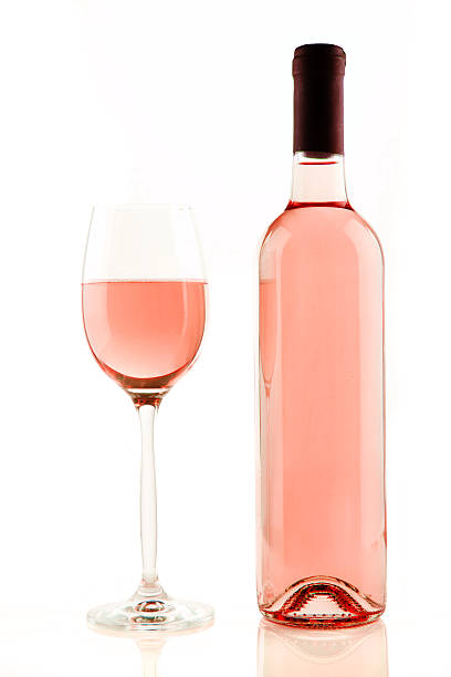 Bottle and glass of rose wine isolated stock photo