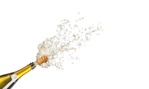 bottle of champagne with splashes of wine stock photo