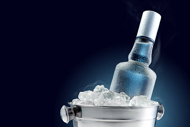 Bottle of cold vodka in bucket of ice stock photo