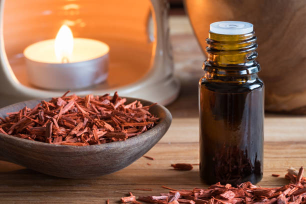 A bottle of sandalwood essential oil with sandalwood stock photo