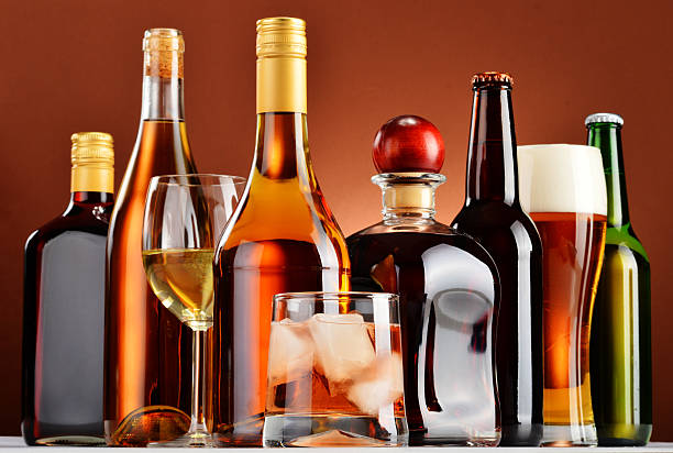 bottles and glasses of assorted alcoholic beverages - alcohol bildbanksfoton och bilder