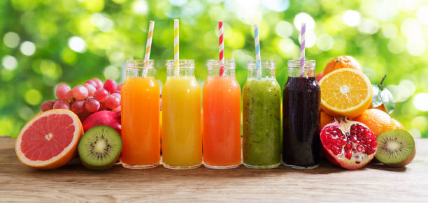 bottles of fruit juice with fresh fruits stock photo