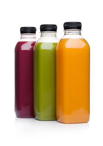 Bottles of healthy fruit juice smoothie on white background