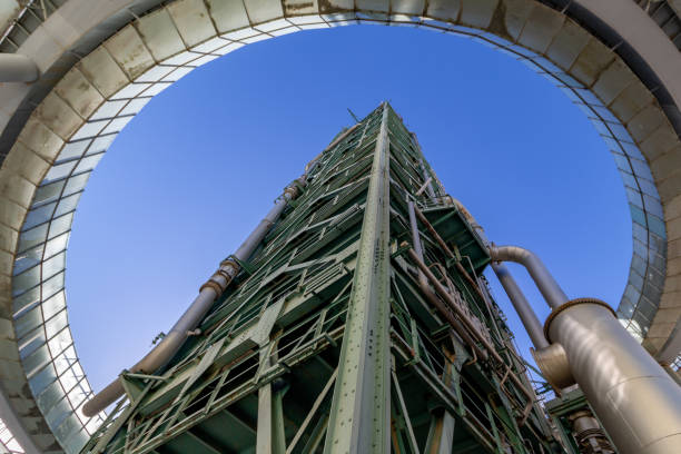 A bottom-up wide-angle view of an abandoned old refinery tower stock photo