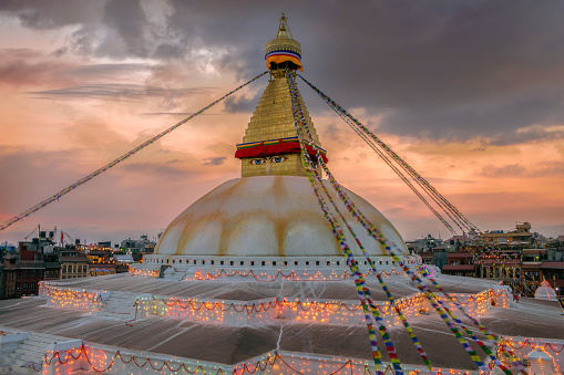 The Boudhanath tample with light in sunset.