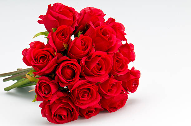 Bouquet of roses Bouquet of artificial red roses, isolated, space for copy in the side. bouquet stock pictures, royalty-free photos & images