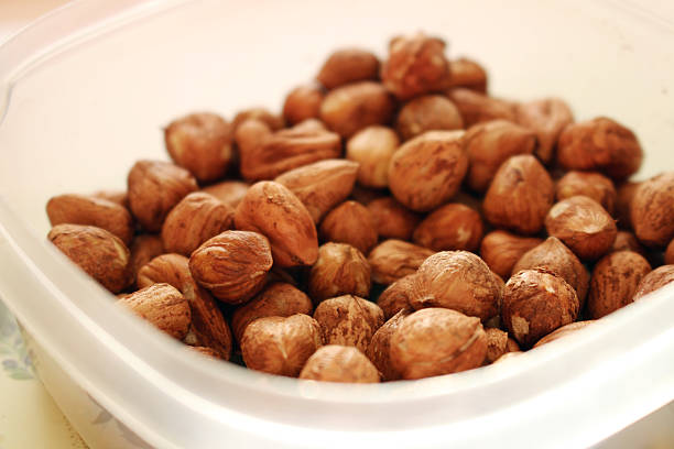 Bowl full of tasty and healthy hazelnuts stock photo