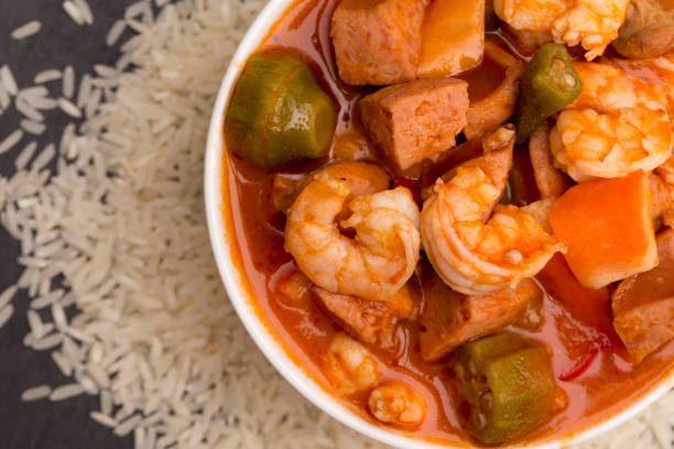 A Bowl of Cajun Seafood Gumbo on a Slate Countertop A Bowl of Cajun Seafood Gumbo on a Slate Countertop gumbo stock pictures, royalty-free photos & images