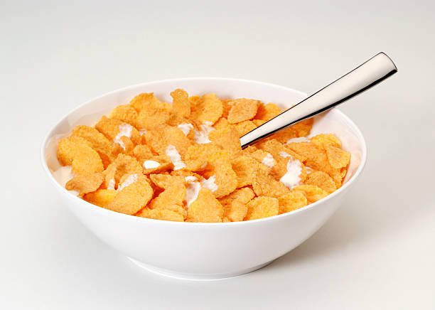 Bowl of corn flakes with spoon stock photo