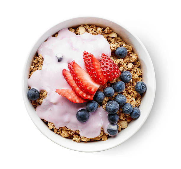 bowl of granola with yogurt and berries bowl of granola with yogurt and berries isolated on white background, top view bowl stock pictures, royalty-free photos & images