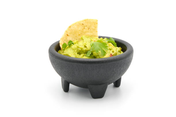 Bowl of Guacamole Bowl of fresh homemade guacamole with a white background. guacamole stock pictures, royalty-free photos & images