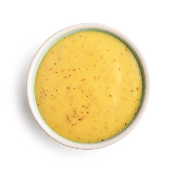 Bowl of mustard and honey sauce stock photo