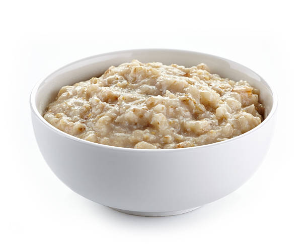 Bowl of oats porridge Bowl of oats porridge on a white background bowl stock pictures, royalty-free photos & images