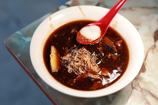 Lor mee is a Hokkien noodle dish from Penang served in a thick starchy gravy. The thick gravy is made of corn starch, spices, meat, seafoods and eggs. Popular street food in Penang, Malaysia.