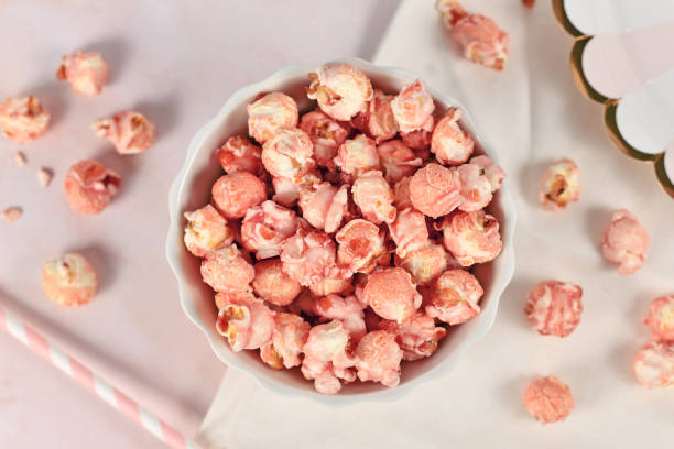 Bowl of pink colored strawberry flavored popcorn stock photo