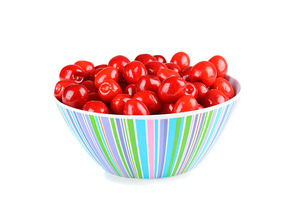 Bowl of red cherries isolated on white stock photo