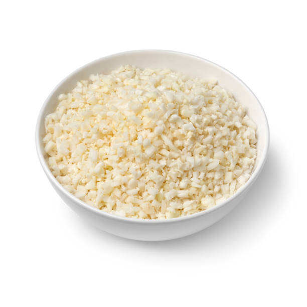 Bowl with fresh cut cauliflower rice on white background stock photo