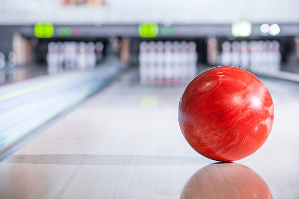 Bowling ball with pins. bowling ball going down the lane in a five pin bowling alley individual event stock pictures, royalty-free photos & images