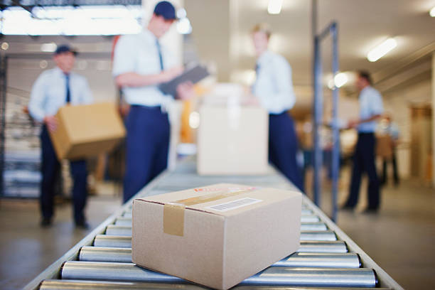 Box on conveyor belt in shipping area  conveyor belt stock pictures, royalty-free photos & images