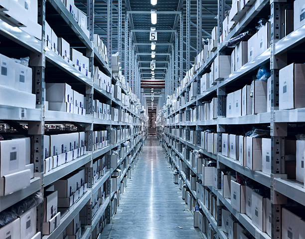 Boxes on shelves in a well lit modern warehouse stock photo