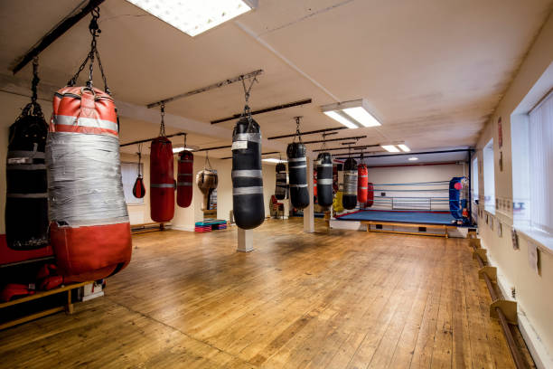Boxing Ring and Fitness Gym Open plan gym with a boxing ring and several varieties of punch bags hanging from the ceiling. The room looks tidy. No People boxing ring stock pictures, royalty-free photos & images