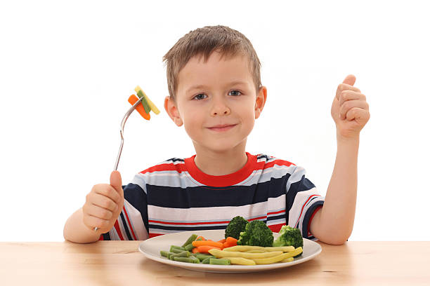 boy and vegetables stock photo