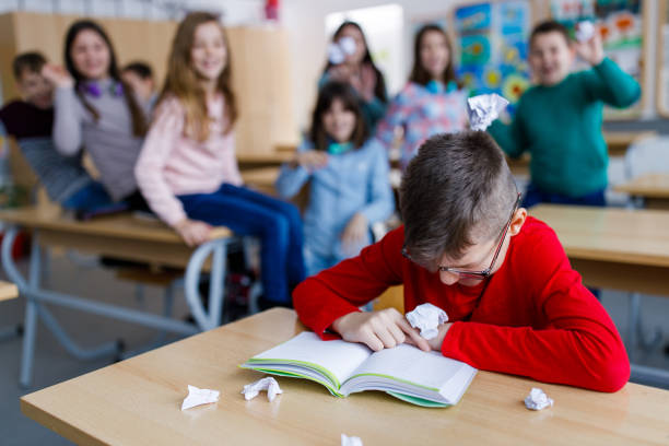 Boy being bullied at school stock photo