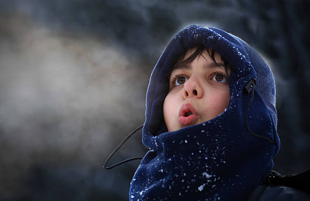 Boy breath in winter 10 years old boy breathing in winter; the boy is wearing a balaklava breath vapor stock pictures, royalty-free photos & images